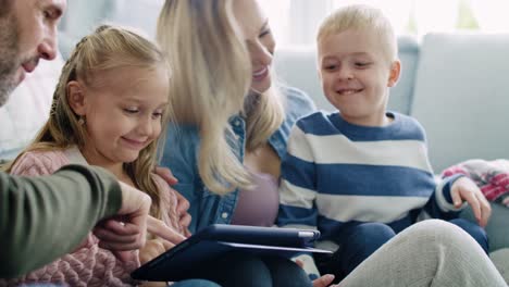 happy family using a tablet in living room