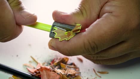 Footage-of-hands-slowly-sharpening-a-pencil-and-some-coloured-pencils-with-a-Wedge-Pencil-Sharpener