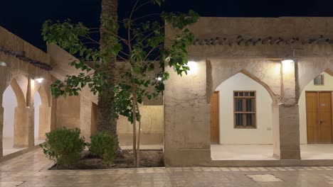 a traditional architecture art designed persian arabic local people houses by arches pattern mudbrick structure jujube tree in the yard at night in doha qatar middle east relax peace safe calm light