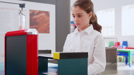 Young-white-girl-using-a-graphics-tablet-at-a-science-centre