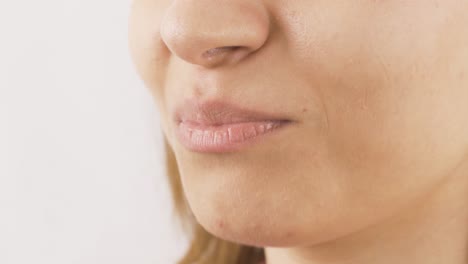 close-up of woman eating jelly beans.