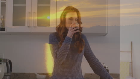 animación de paisaje de puesta de sol sobre mujer caucásica bebiendo café en la cocina