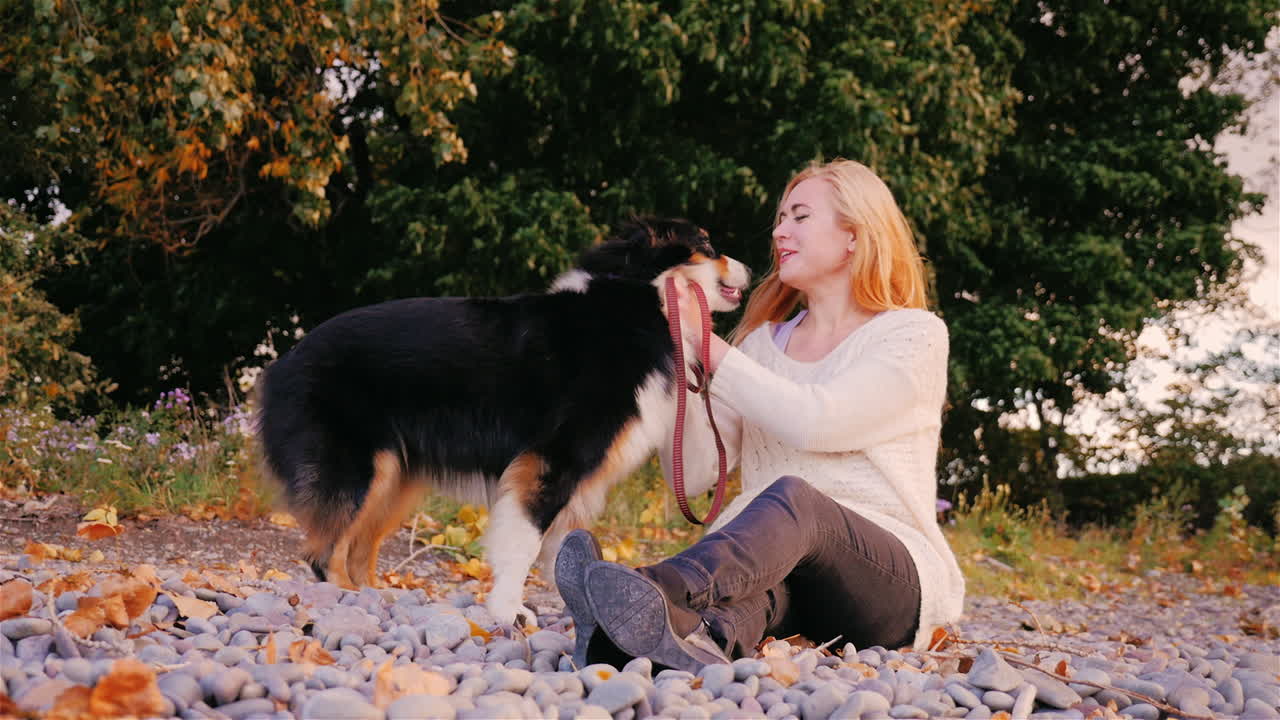 호숫가에서 개와 노는 젊은 여성 3