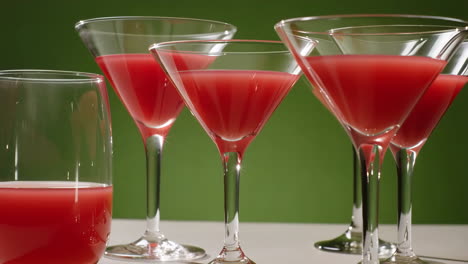 red cocktails in martini glasses