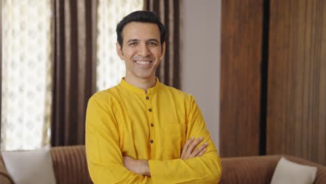 proud indian man standing crossed hands in ethnic outfit