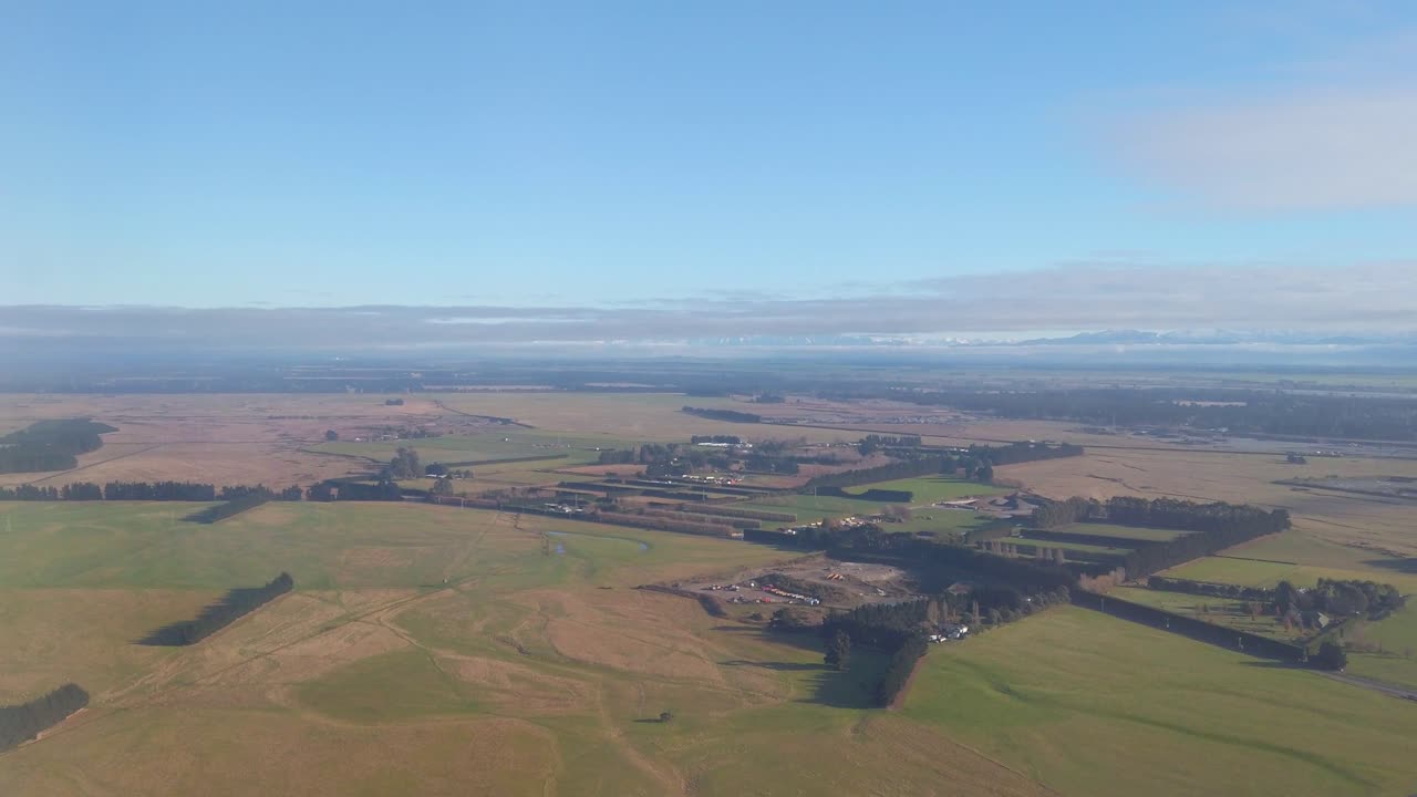 Aerial rising up over farmland