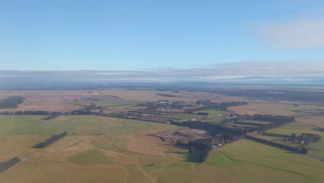 aerial rising up over farmland