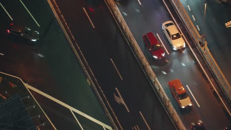 vehicles driving on highway in shibuya at night in tokyo, japan