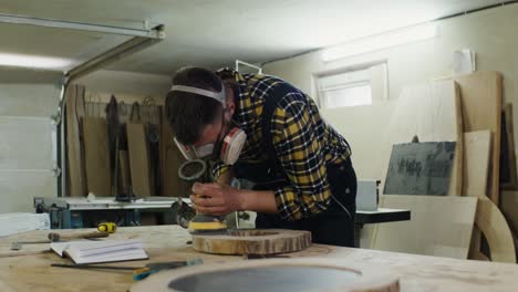 woodworker sanding a wood slab