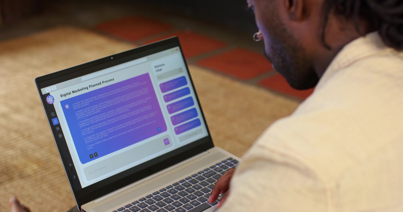 African man on rug opening laptop, reading marketing plan, typing, preparing campaign, copy space
