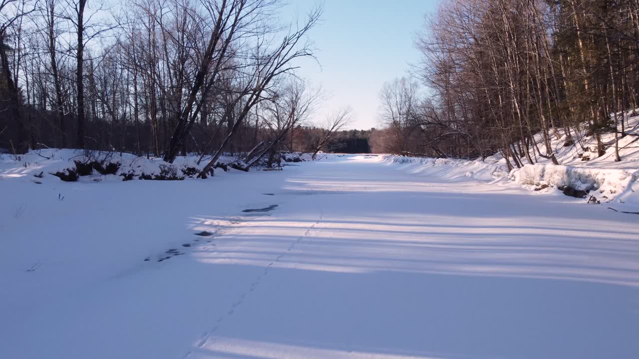 Snow-covered road through nature in Sherbrooke