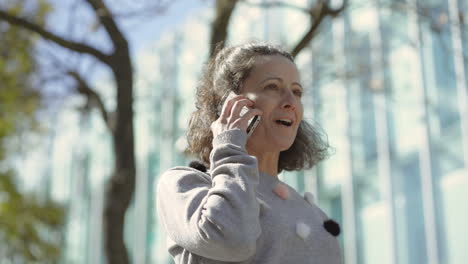 bottom view of happy mature woman talking on smartphone.