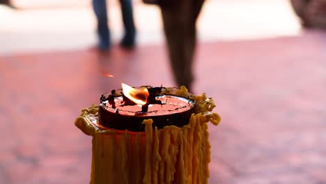 person lighting a candle with a matchstick