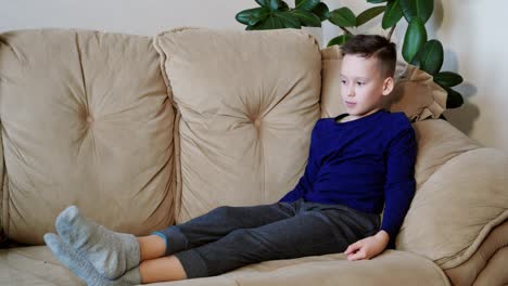 cute kid playing games on smartphone. little boy playing tablet game. peaceful pastime.