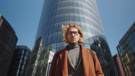 portrait of handsome businessman in front of office building