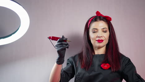 cosmetologist making permanent makeup. beautician female holding equipment and preparing to applying permanent makeup on lips