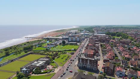 Panoramic Aerial View of a Coastal Town and Beach with a Pier
