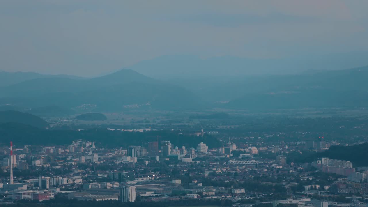 Night View of a City Nestled in the Mountains