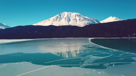 4K-Drone-Video-of-Snow-Covered-Lakeside-Mountains-in-Alaska-During-Winter