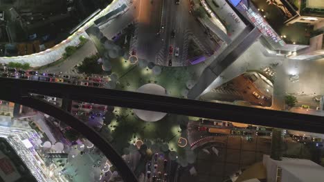 aerial top down of traffic roundabout in business district with car and mrt skytrain