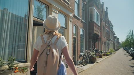 woman in a hat walking through delft