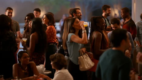 a diverse group of people socializing at a lively indoor event