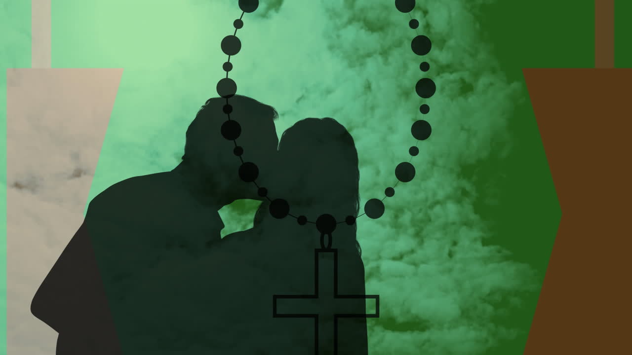 Embracing couple with rosary beads silhouetted against green cloudy background