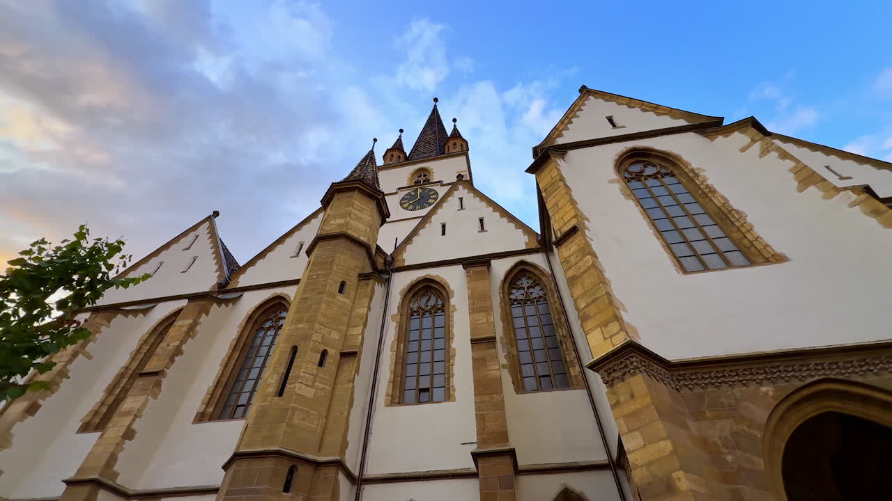 Coming close to the façade of Lutheran Cathedral of Saint Mary in Sibiu, Romania. Beautiful sky at backdrop