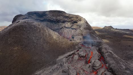 Aerial-Of-Hot-Molten-Lava-Boulder-Falling-Into-A-Pool-From-Fagradalsfjall-Volcano-On-The-Reykjanes-Peninsula-In-Iceland