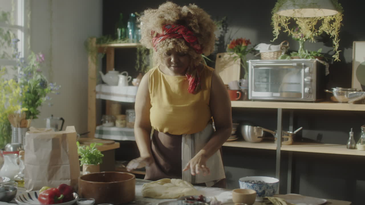 Woman preparing dough in a rustic home kitchen