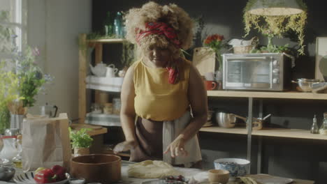 woman preparing dough in a rustic home kitchen