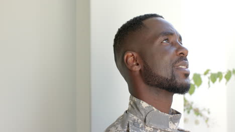 African-American-man-in-military-uniform-smiles-contentedly-at-home