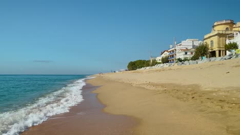 Platja-de-les-Barques-sea-field-Maresme-Barcelona-Mediterranean-coast-plane-close-to-turquoise-blue-transparent-water-beach-without-people