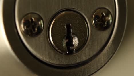 key inserted into deadbolt door lock and turned to right quickly and removed residential close up