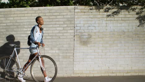 Woman-walking-with-bicycle-on-a-sidewalk-4k