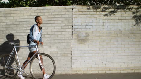 woman walking with bicycle on a sidewalk 4k