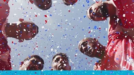 Colorful-confetti-falling-against-team-of-male-soccer-players-forming-a-huddle