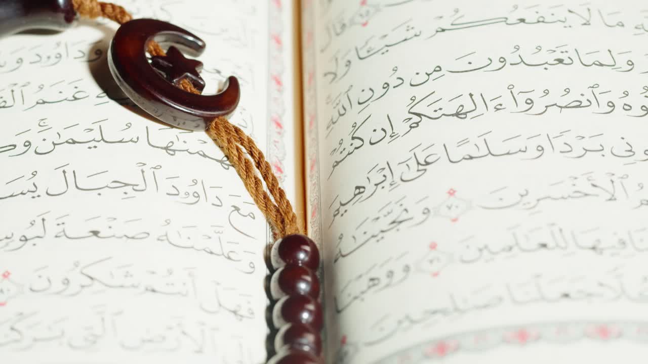 Holy Quran and Prayer Beads with Islamic Symbols