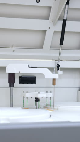 large laboratory machine working and producing biomedical testing of blood. advanced innovative equipment in science lab. vertical video