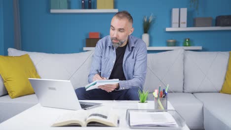 Man-working-from-home-attends-online-meeting.