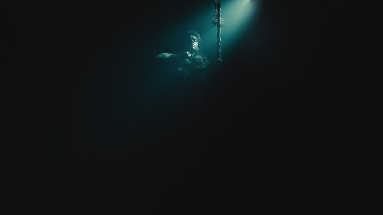 The witch makes a gesture of cutting her throat