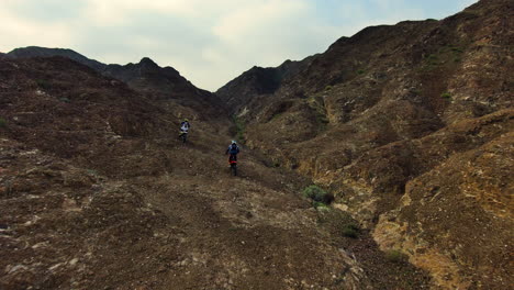 enduro bikes riding across the mountains in the uae