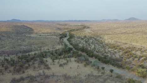 Aerial-View-Over-Dry-Riverbed-Landscape,-Etosha-National-Park,-Namibia