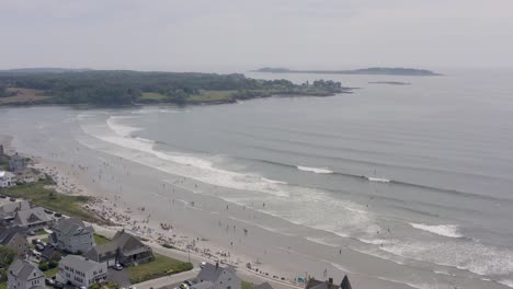 drone flying over crowd of people at higgins beach in maine