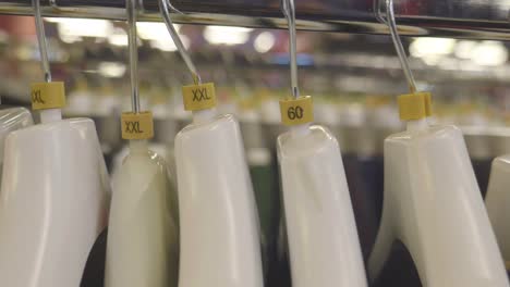 close up of white hangers with clothing sizes, showing the size xl and xxl