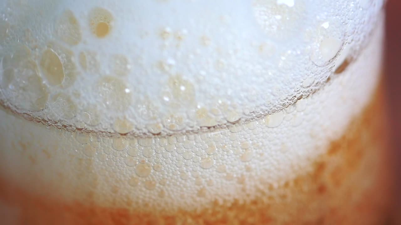 Detailed super slow motion footage of a beer