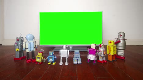 retro robots walking into a room to watch a presentation stop motion and green screen