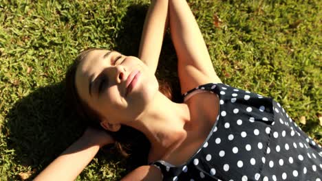 woman lying on grass in park