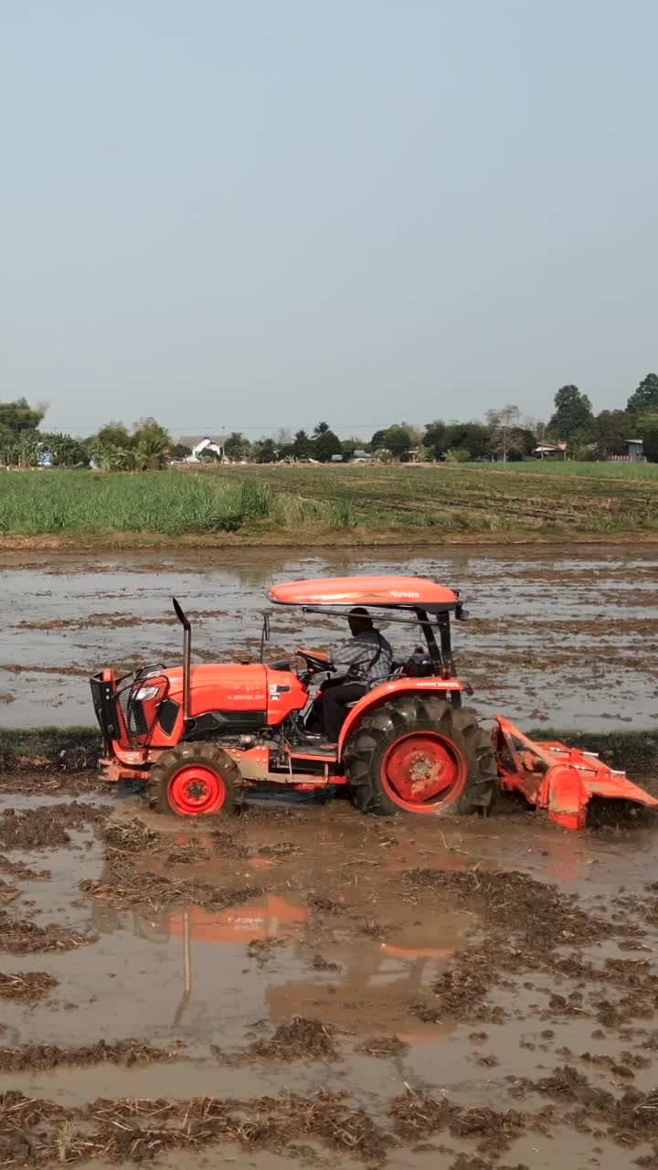Tractor working in a muddy field