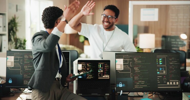 Software Developers Collaborating on Coding Project in Modern Office